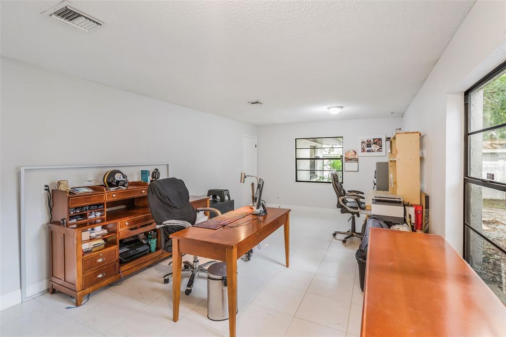 1760 12th Street Clermont, FL 34711 - Photo 23 of 42 a view of a workspace with furniture and a window