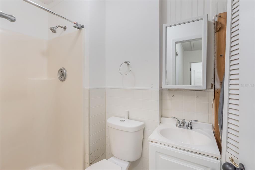 1760 12th Street Clermont, FL 34711 - Photo 25 of 42 a bathroom with a sink a toilet and shower