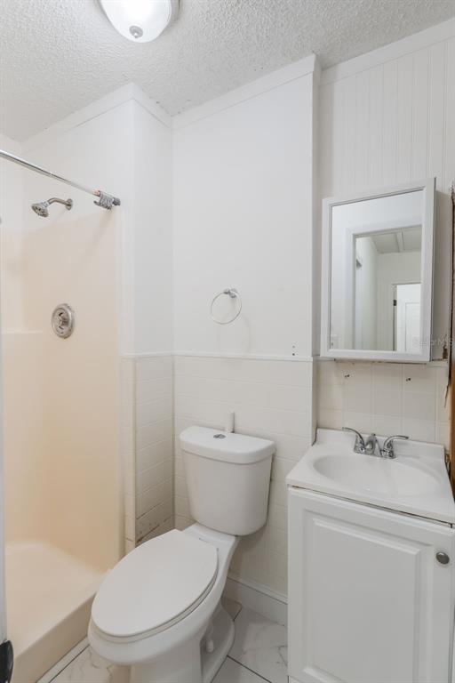 1760 12th Street Clermont, FL 34711 - Photo 26 of 42 a white toilet sitting next to a bathroom sink