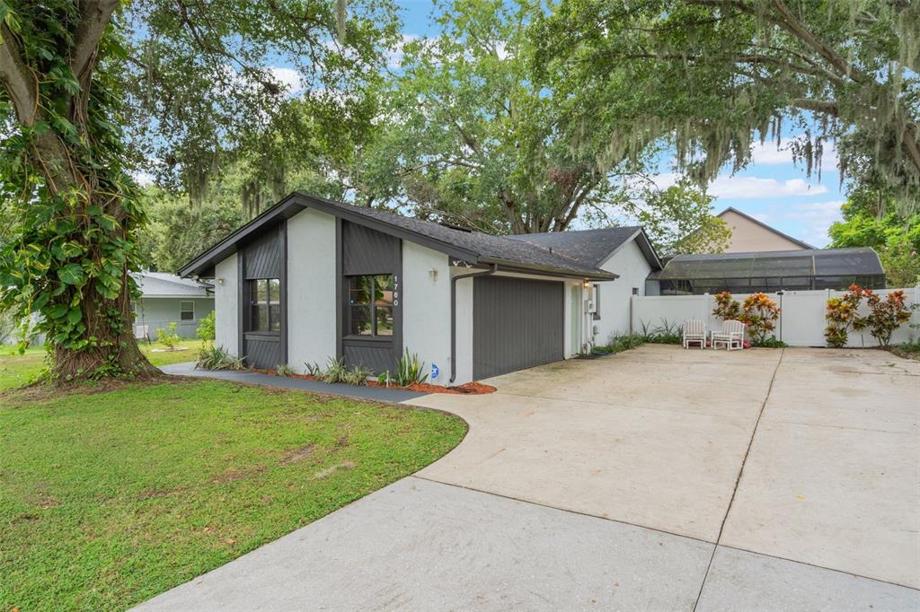 1760 12th Street Clermont, FL 34711 - Photo 3 of 42 a view of a house with a yard and large tree