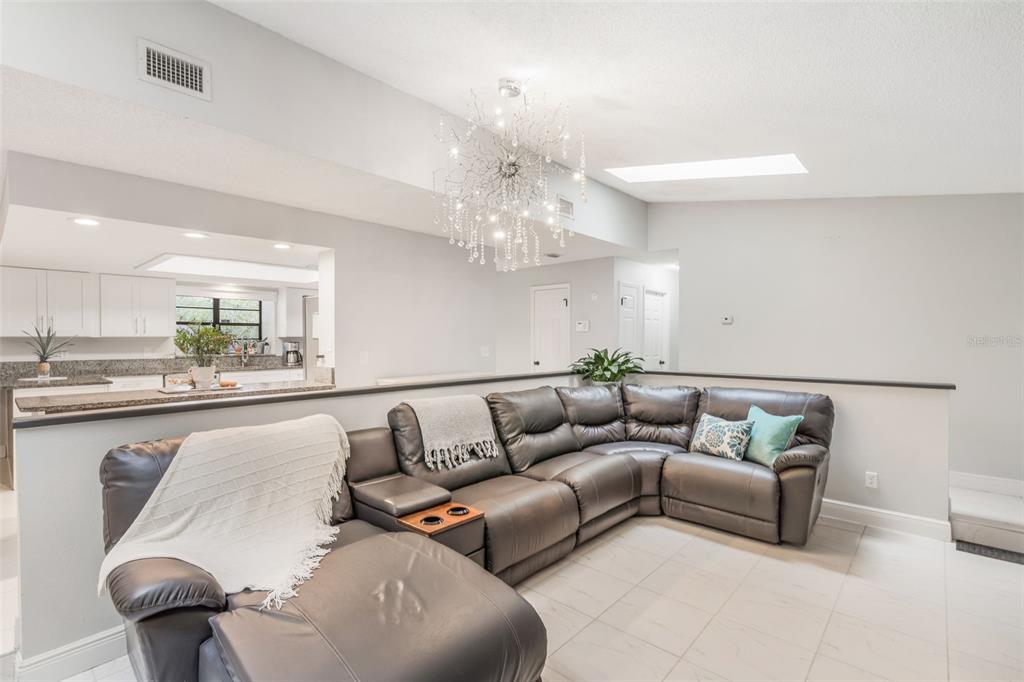 1760 12th Street Clermont, FL 34711 - Photo 8 of 42 a living room with furniture and a chandelier