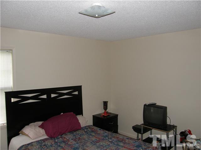 8107 Farmlea Circle Raleigh, NC 27616 - Photo 2 of 6 a bedroom with a bed and cabinets