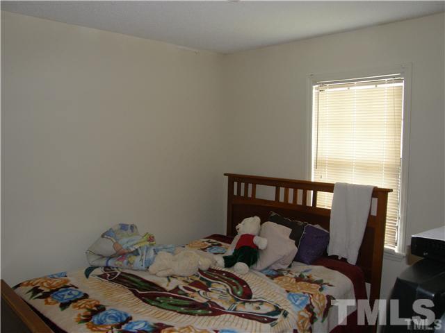 8107 Farmlea Circle Raleigh, NC 27616 - Photo 4 of 6 a bedroom with a bed and wooden floor