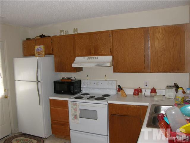 8107 Farmlea Circle Raleigh, NC 27616 - Photo 5 of 6 a kitchen with a refrigerator and a sink