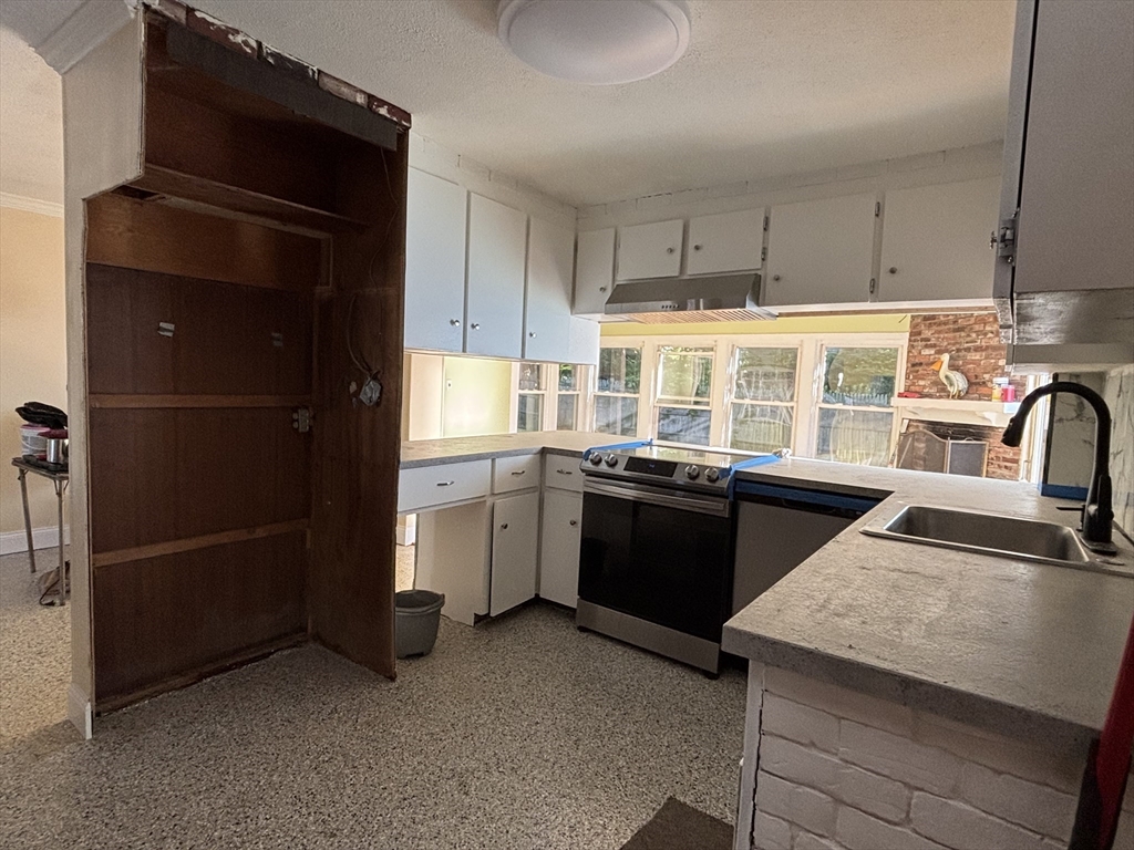 215 Jaffrey Street, Unit 1 Weymouth, MA 02188 - Photo 2 of 8 a kitchen with a refrigerator and a sink