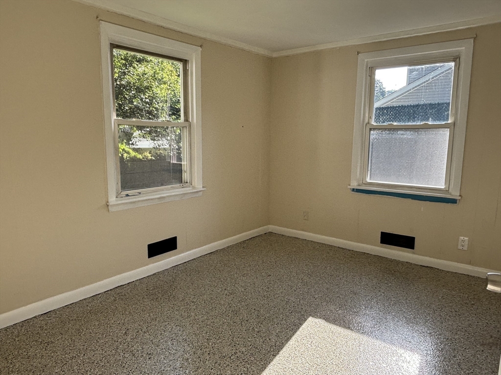 215 Jaffrey Street, Unit 1 Weymouth, MA 02188 - Photo 4 of 8 an empty room with windows