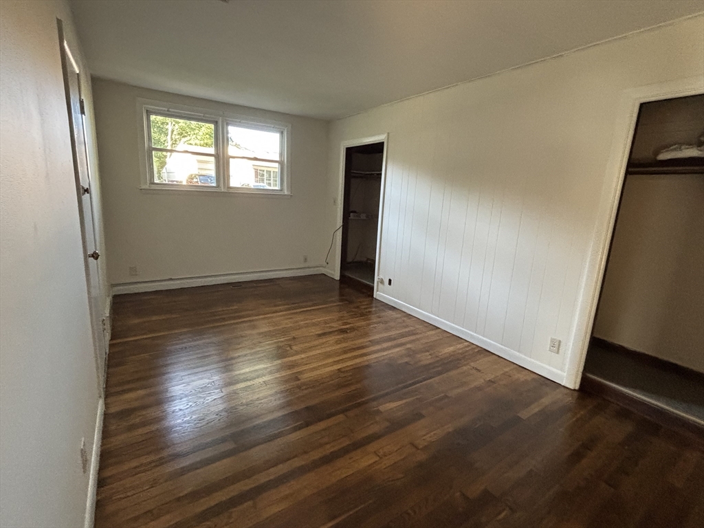 215 Jaffrey Street, Unit 1 Weymouth, MA 02188 - Photo 6 of 8 an empty room with wooden floor and windows