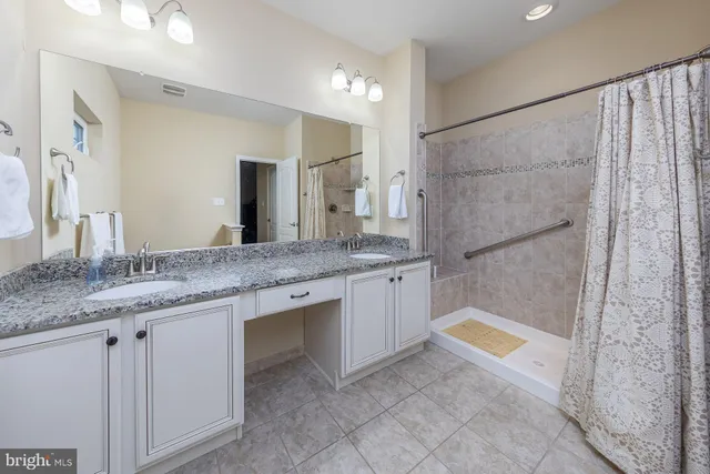 a bathroom with a granite countertop sink mirror and a