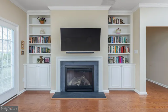 a living room with a fireplace and a flat screen tv
