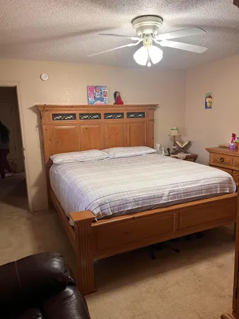 a bedroom with bed and a chandelier