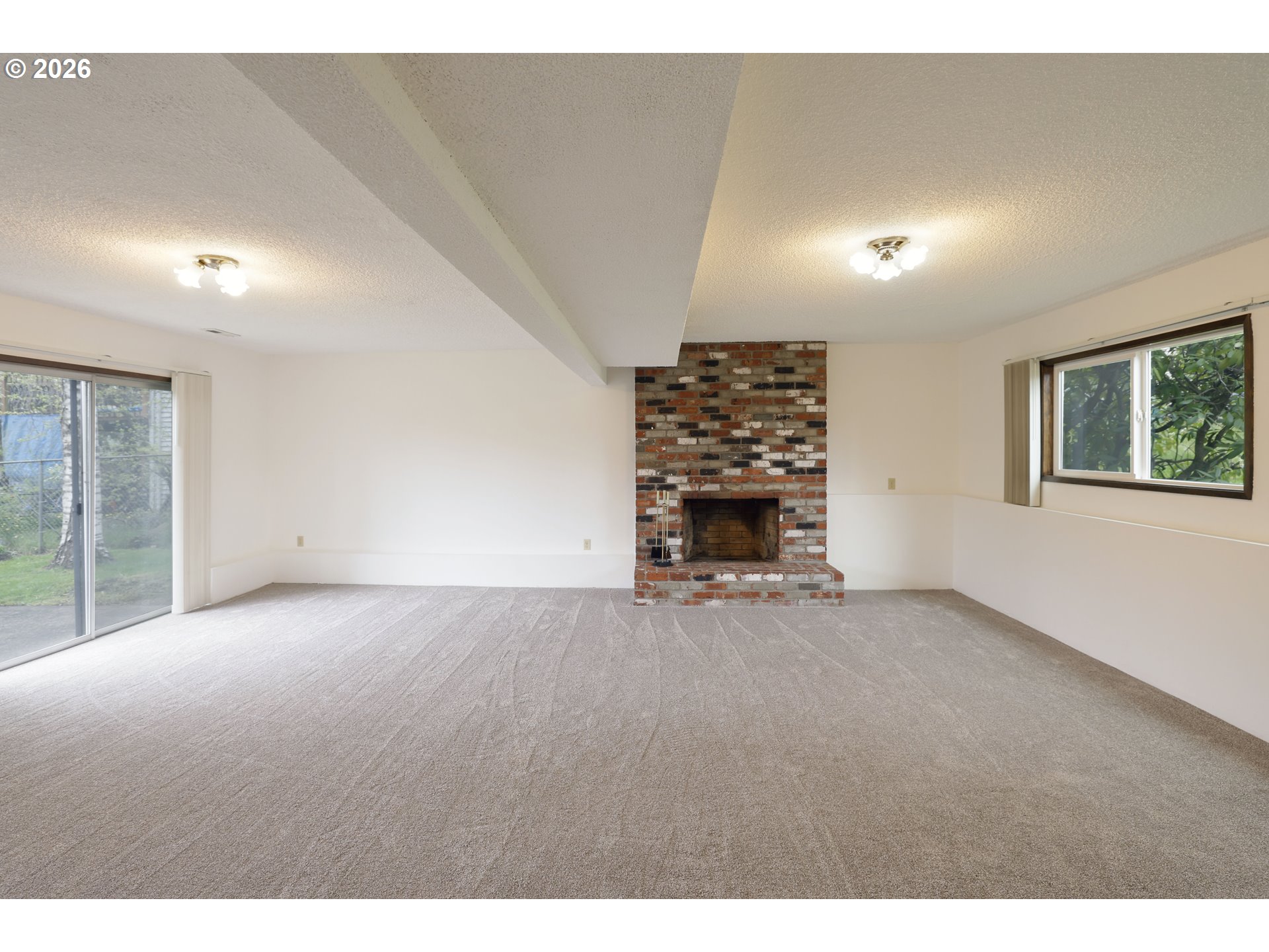 16285 Southwest Rosa Road Beaverton, OR 97007 - Photo 13 of 20 a view of an empty room with a fireplace and a window