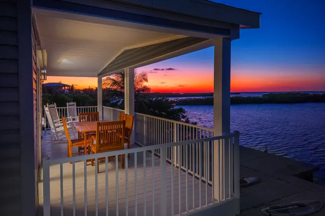 a view of roof deck with wooden floor and fence