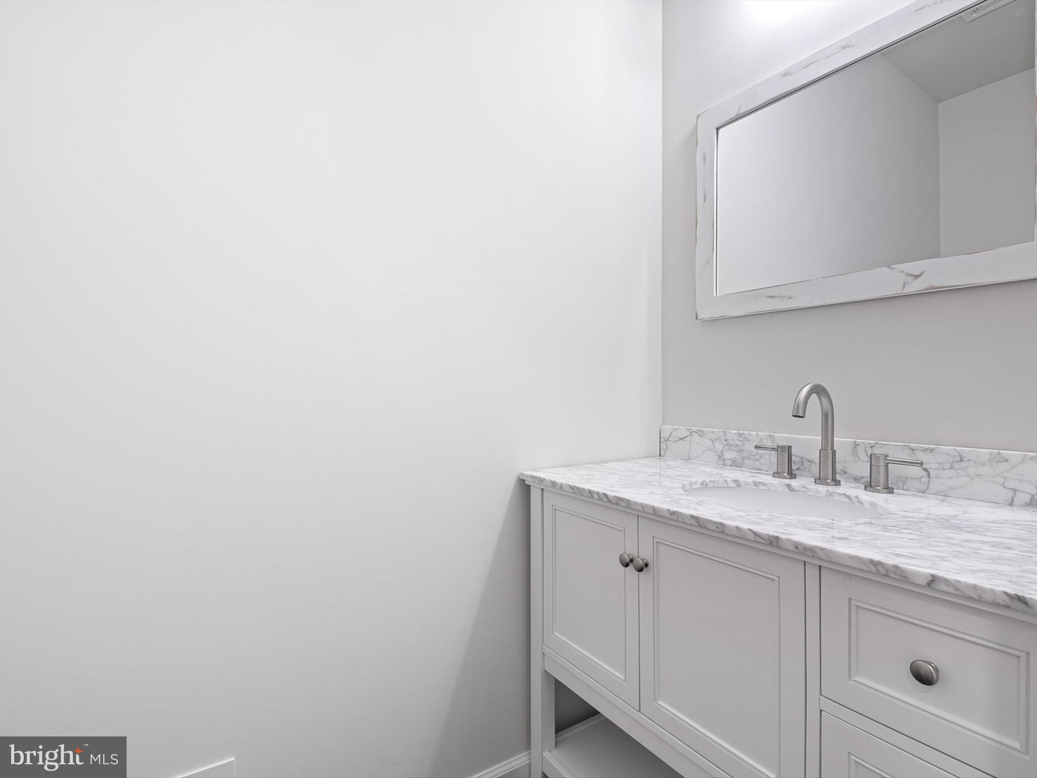 154 Pine Tree Road Townsend, DE 19734 - Photo 29 of 33 a bathroom with a granite countertop sink and a mirror