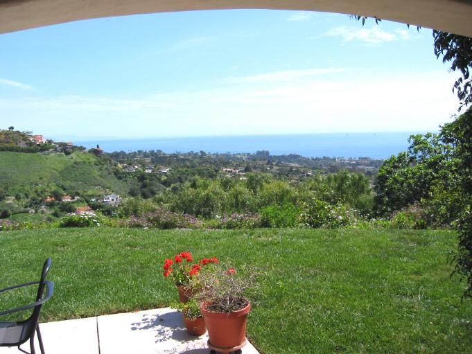 656 Las Alturas Road Santa Barbara, CA 93103 - Photo 1 of 8 a view of a table and a chairs in a garden