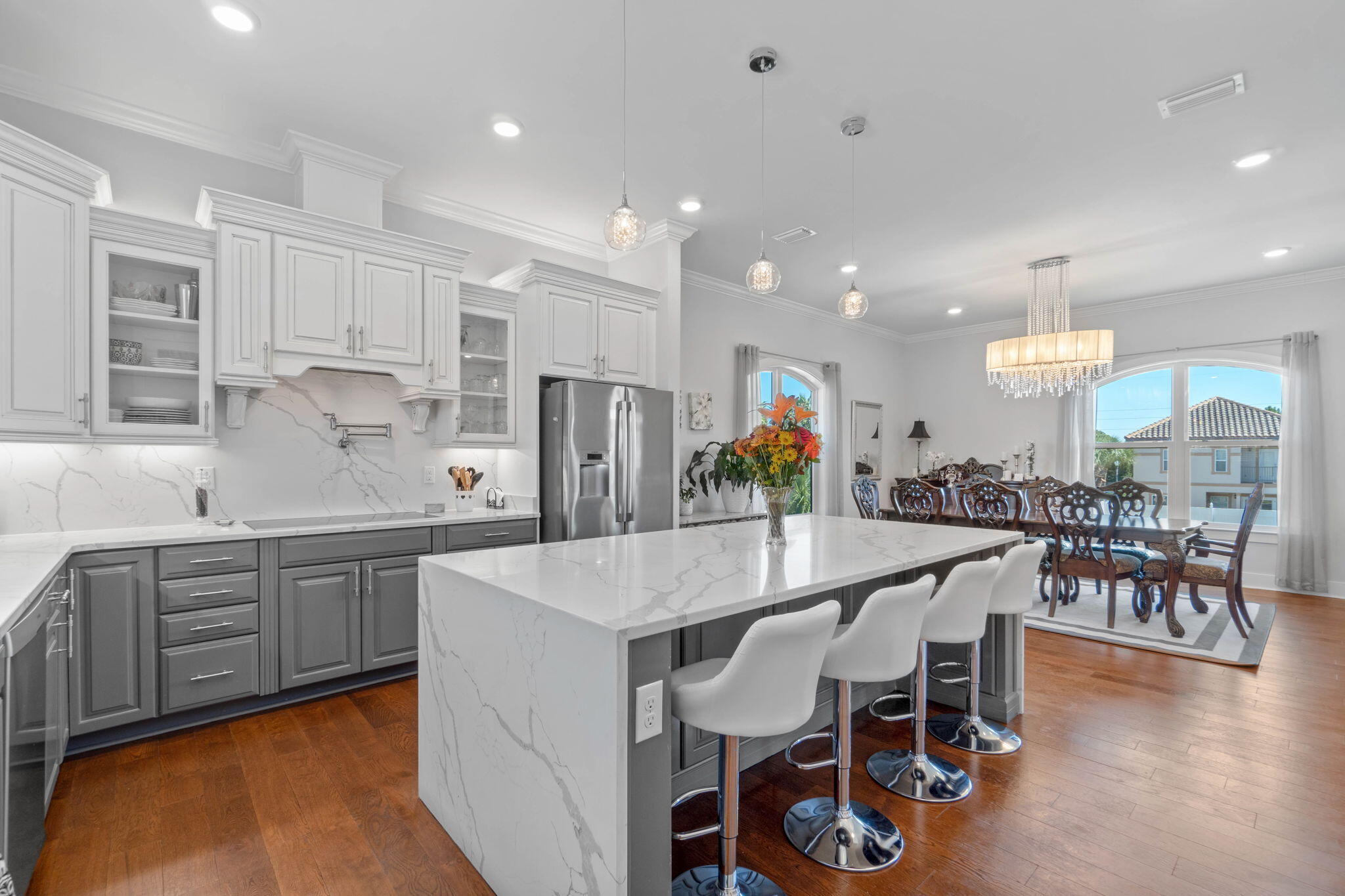 234 Inverrary Drive Destin, FL 32541 - Photo 16 of 53 a large kitchen with stainless steel appliances a dining table chairs and granite counter tops