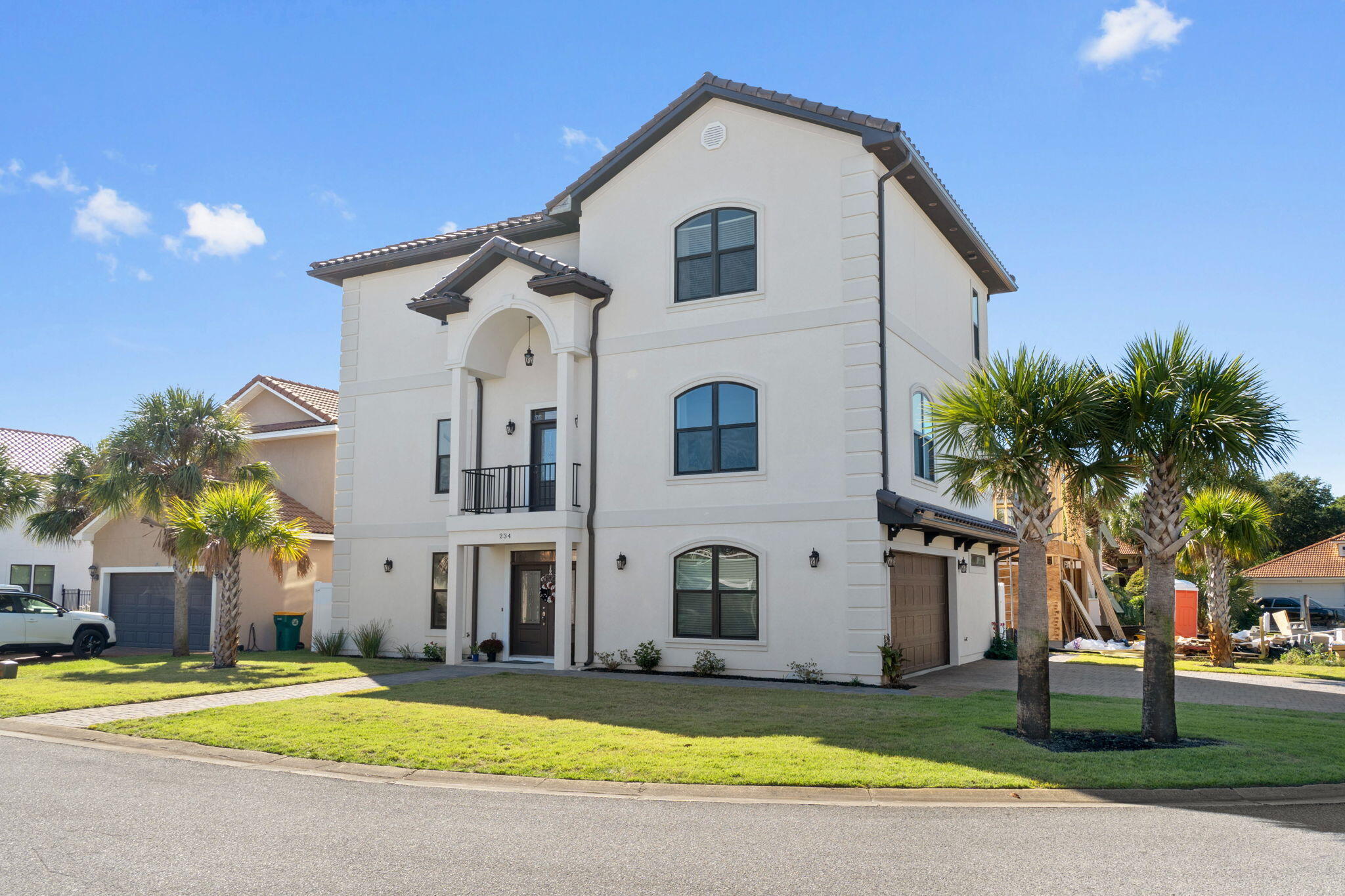 234 Inverrary Drive Destin, FL 32541 - Photo 2 of 53 a view of a white house with a large windows and a yard with plants