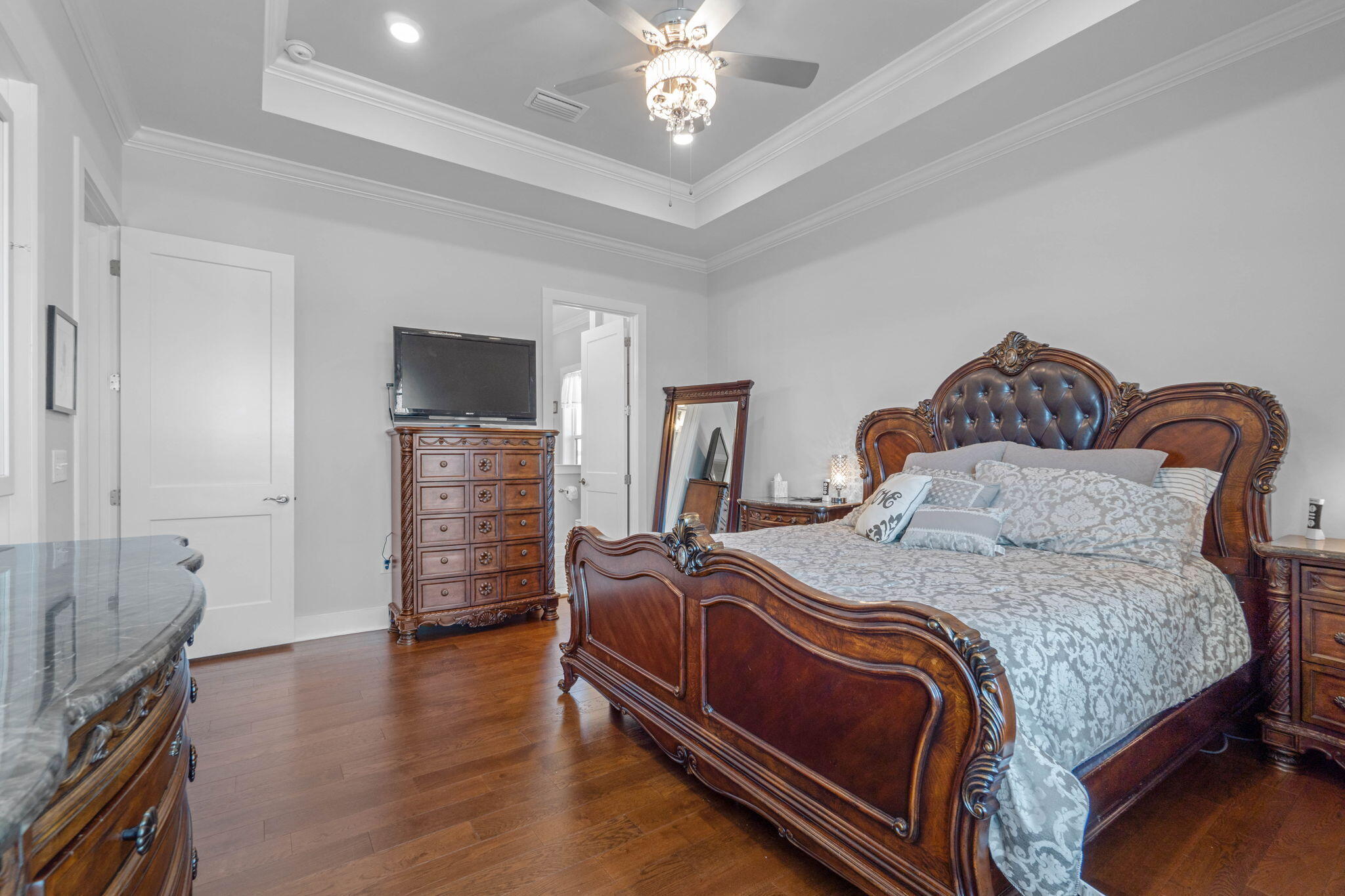 234 Inverrary Drive Destin, FL 32541 - Photo 26 of 53 a bedroom with bed and a chandelier