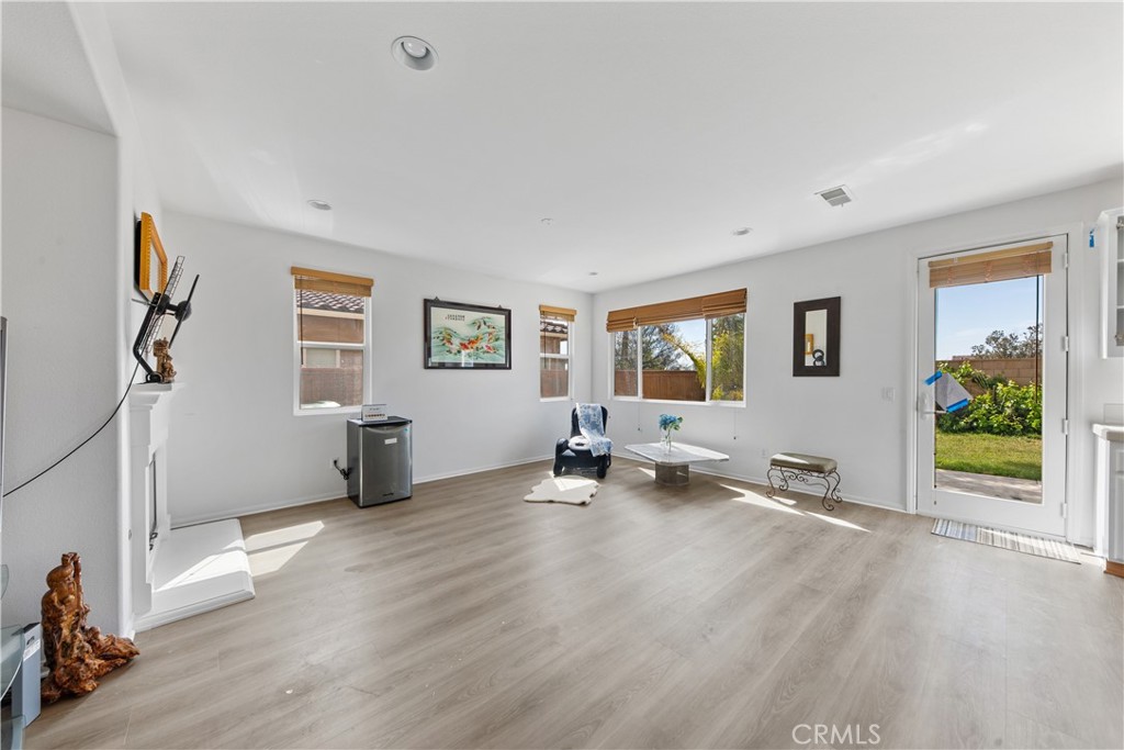 34138 Amici Street Temecula, CA 92592 - Photo 11 of 45 a view of a livingroom with wooden floor and a ceiling fan