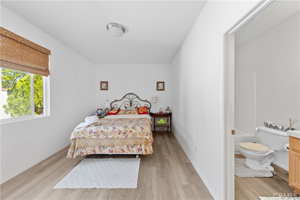 34138 Amici Street Temecula, CA 92592 - Photo 16 of 45 a bedroom with a bed and wooden floor