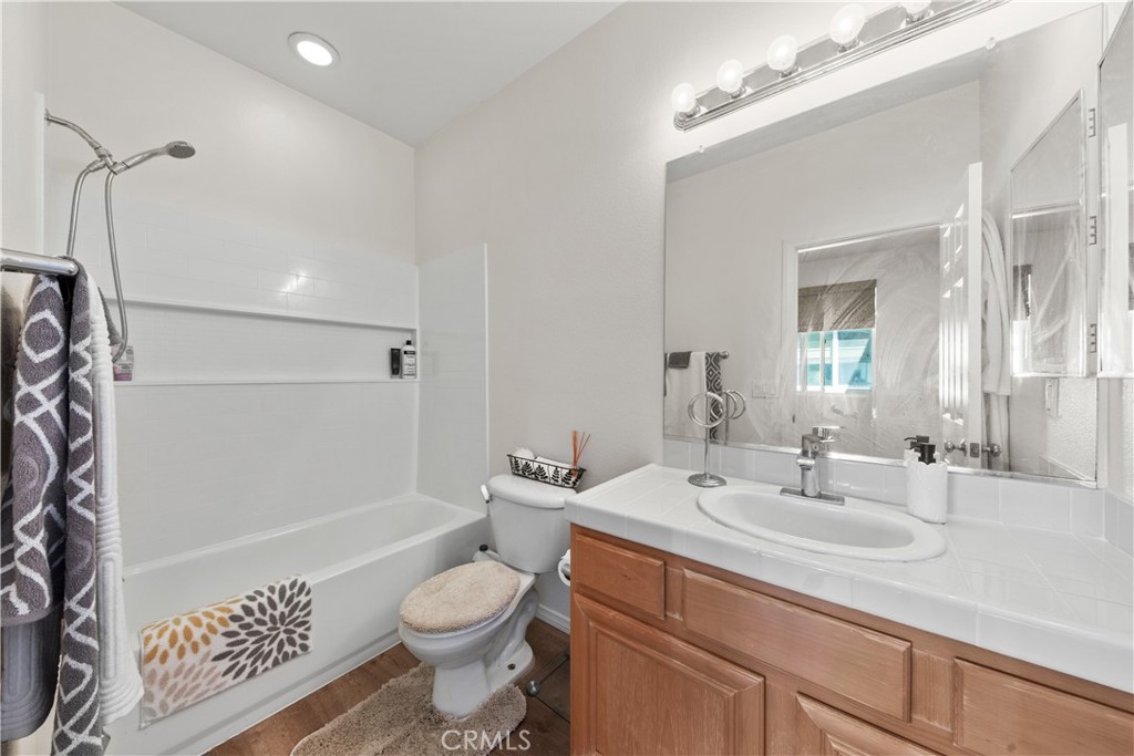 34138 Amici Street Temecula, CA 92592 - Photo 17 of 45 a bathroom with a sink a toilet and shower