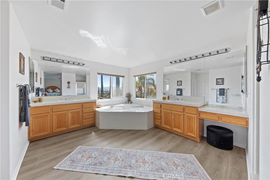 34138 Amici Street Temecula, CA 92592 - Photo 24 of 45 a large white kitchen with cabinets a sink and appliances