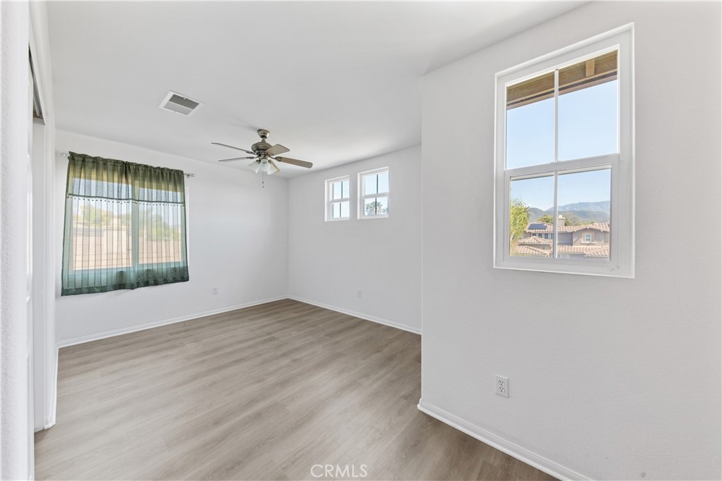 34138 Amici Street Temecula, CA 92592 - Photo 28 of 45 an empty room with windows and closet