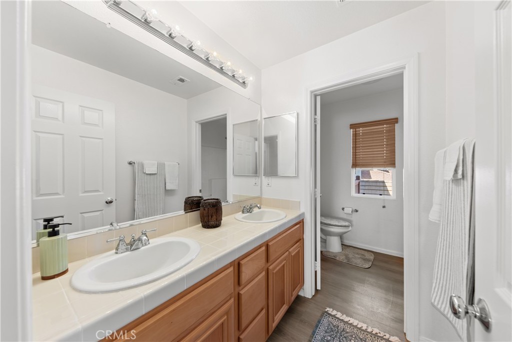 34138 Amici Street Temecula, CA 92592 - Photo 29 of 45 a spacious bathroom with a double vanity sink mirror and toilet