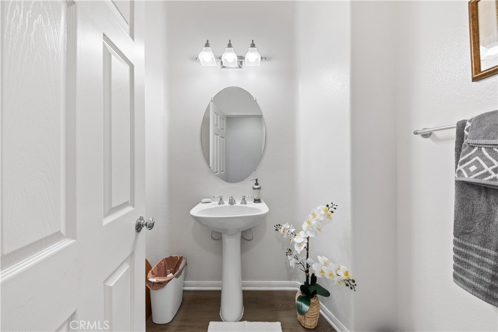 34138 Amici Street Temecula, CA 92592 - Photo 30 of 45 a bathroom with a toilet sink and mirror