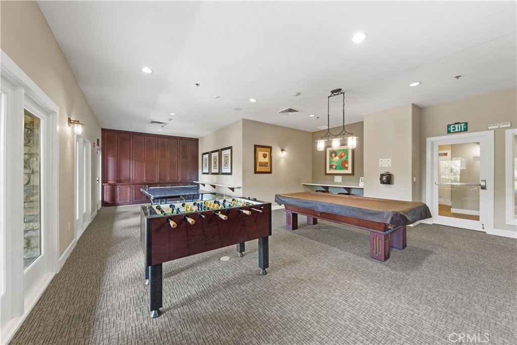 34138 Amici Street Temecula, CA 92592 - Photo 44 of 45 a living room with furniture a table and kitchen view