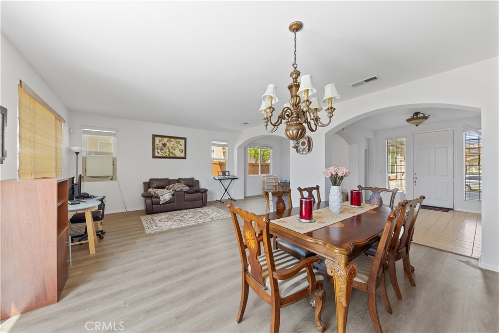 34138 Amici Street Temecula, CA 92592 - Photo 7 of 45 a view of a dining room with furniture and chandelier