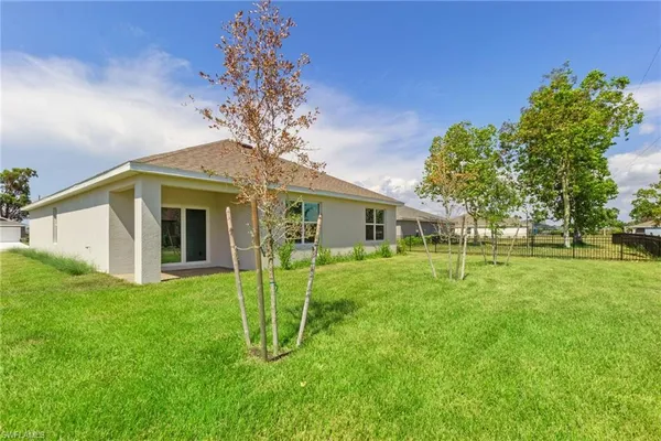 a view of a house with a backyard porch and a garden