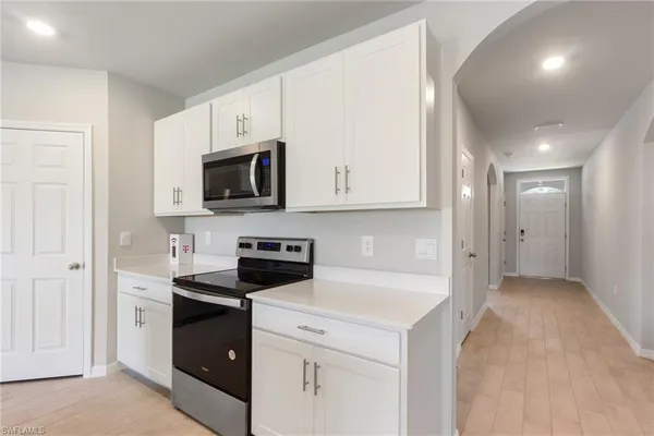a view of a kitchen with electric appliances