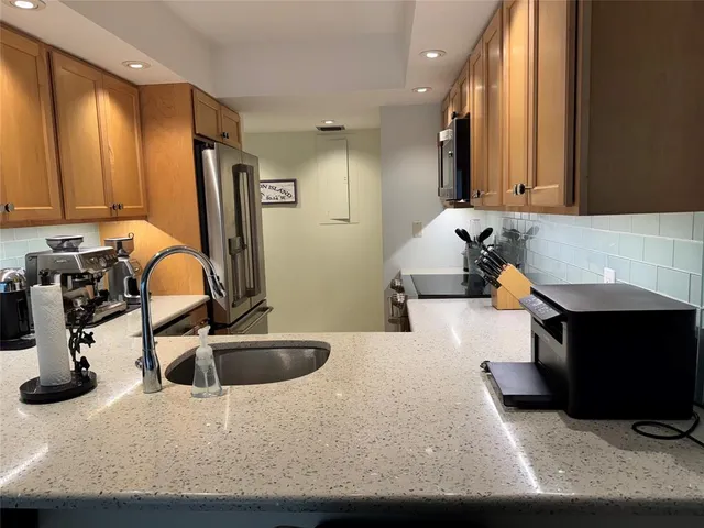 a kitchen with a refrigerator and a sink