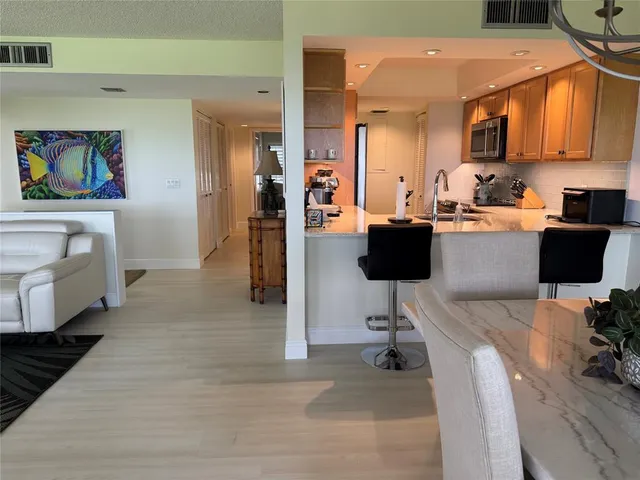 a view of cabinets and living room with a chair