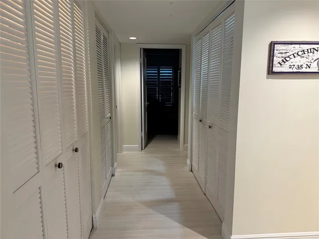a view of a hallway with wooden shelves