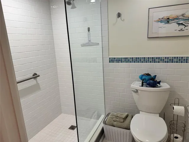 a bathroom with a toilet and a shower