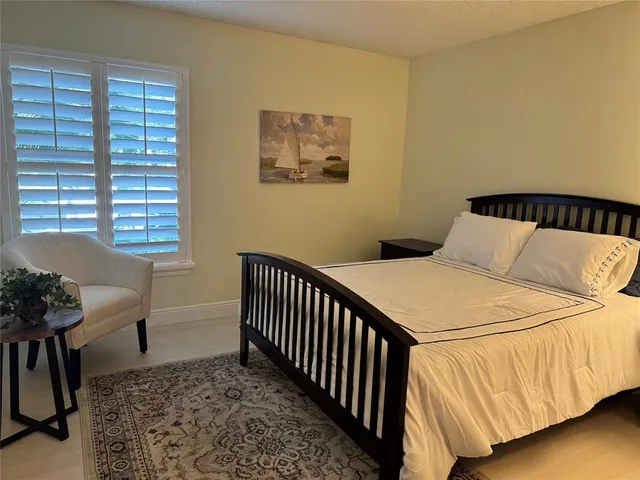 a bedroom with a bed and chair