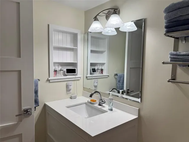 a bathroom with a sink and a mirror
