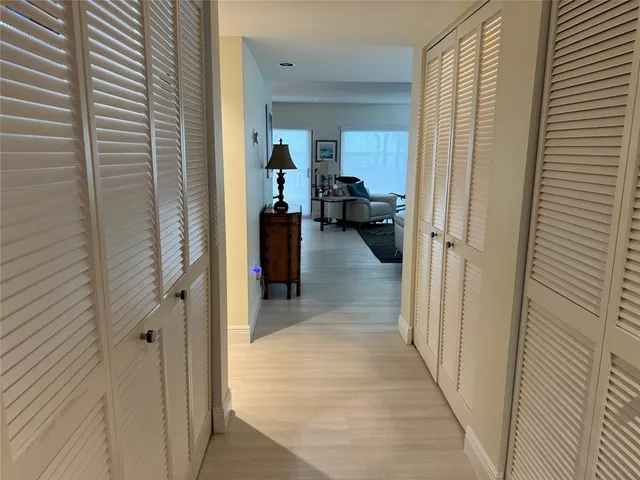 a view of a hallway with a livingroom and a couch