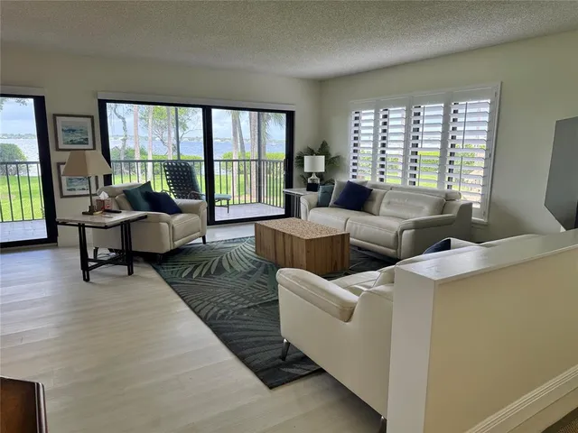 a living room with furniture and large windows