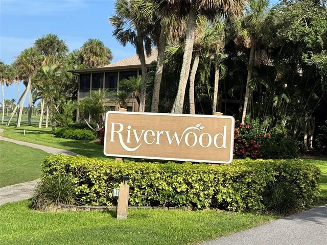 a sign broad in front of the red white house