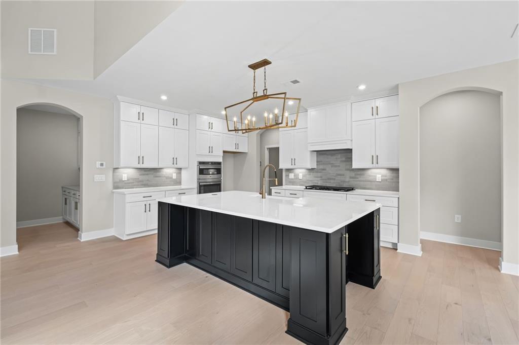 714 Conley Drive Canton, GA 30115 - Photo 14 of 51 a kitchen with a sink a center island cabinets and stainless steel appliances
