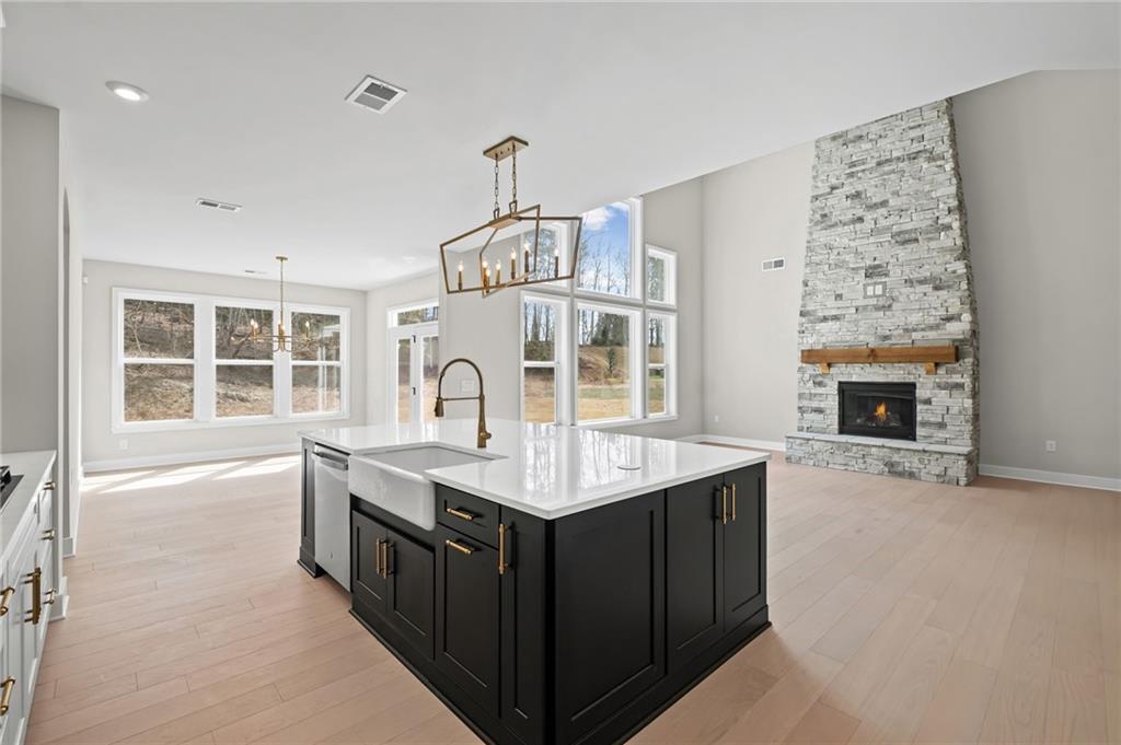 714 Conley Drive Canton, GA 30115 - Photo 16 of 51 a kitchen with a stove kitchen island and couches with wooden floor