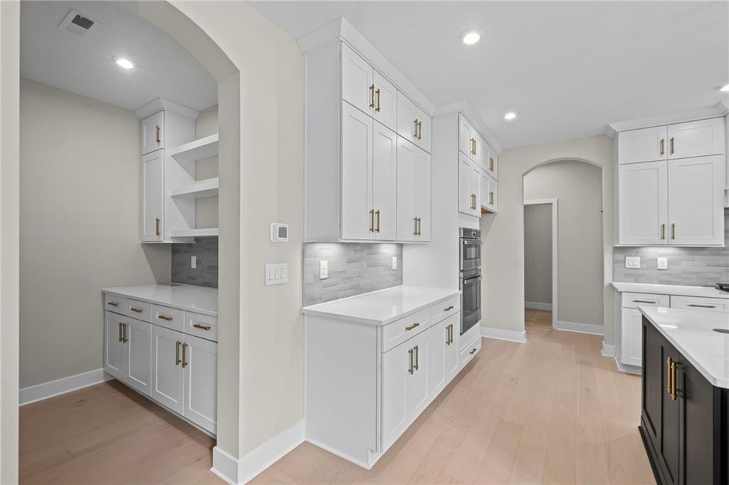 714 Conley Drive Canton, GA 30115 - Photo 18 of 51 a large kitchen with stainless steel appliances and white cabinets