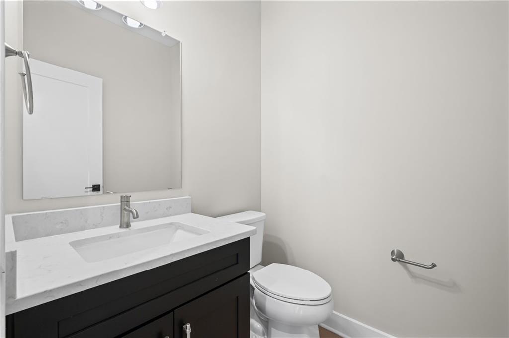 714 Conley Drive Canton, GA 30115 - Photo 22 of 51 a bathroom with a sink a toilet and a mirror