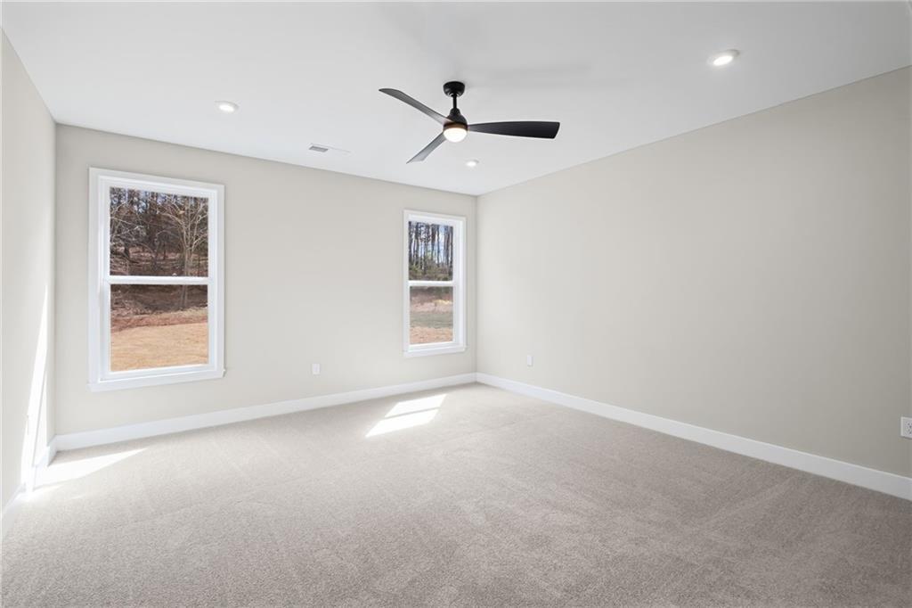 714 Conley Drive Canton, GA 30115 - Photo 23 of 51 en empty room with windows and ceiling fan