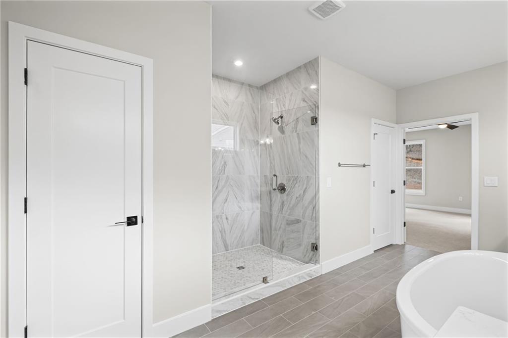 714 Conley Drive Canton, GA 30115 - Photo 27 of 51 a bathroom with a shower and a tub