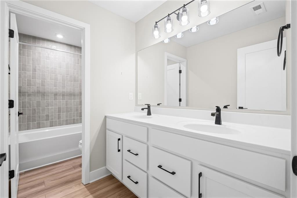 714 Conley Drive Canton, GA 30115 - Photo 38 of 51 a bathroom with a sink double vanity and a mirror
