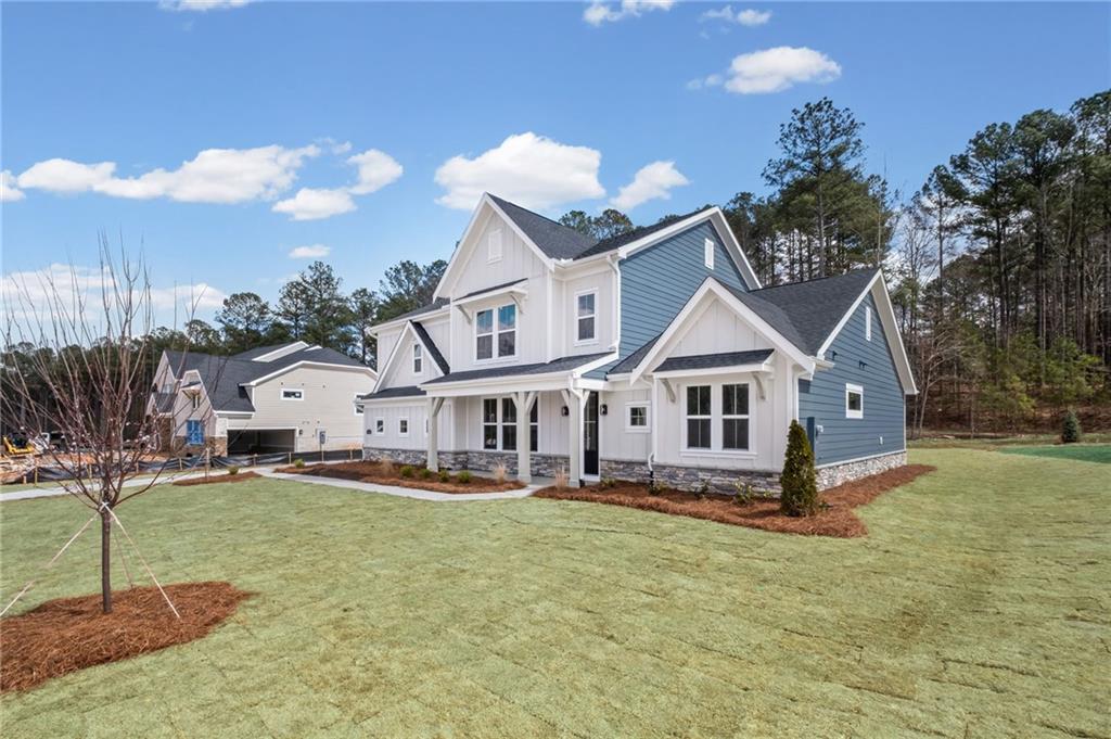 714 Conley Drive Canton, GA 30115 - Photo 5 of 51 a view of a house with a big yard and large trees