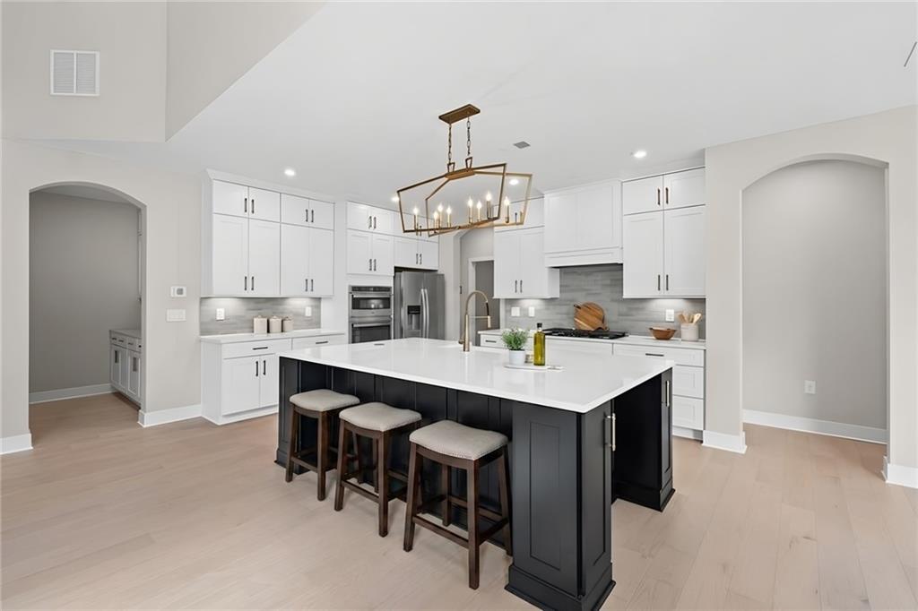 714 Conley Drive Canton, GA 30115 - Photo 7 of 51 a kitchen with kitchen island stainless steel appliances a table and chairs in it
